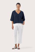 Women's navy linen top featuring a modern relaxed silhouette crafted from breathable natural linen for elegant resort wear and effortless summer styling by By The Sea Bali