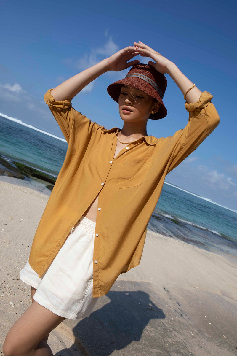 woman wearing raffia hat on the beach in bali