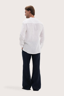 Back view of the white linen shirt with a relaxed and timeless silhouette