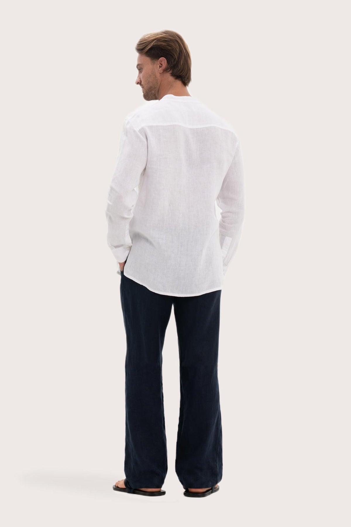 Back view of the white linen shirt with a relaxed and timeless silhouette