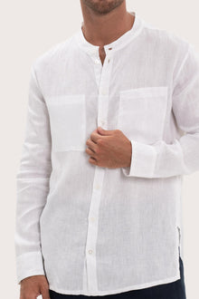 Close-up of the linen fabric texture and refined tailoring details on the white shirt