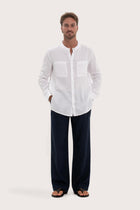 Model wearing the white linen Abra shirt by By The Sea Bali