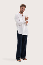 Side profile of the white linen Abra shirt showcasing its effortless drape and comfortable fit