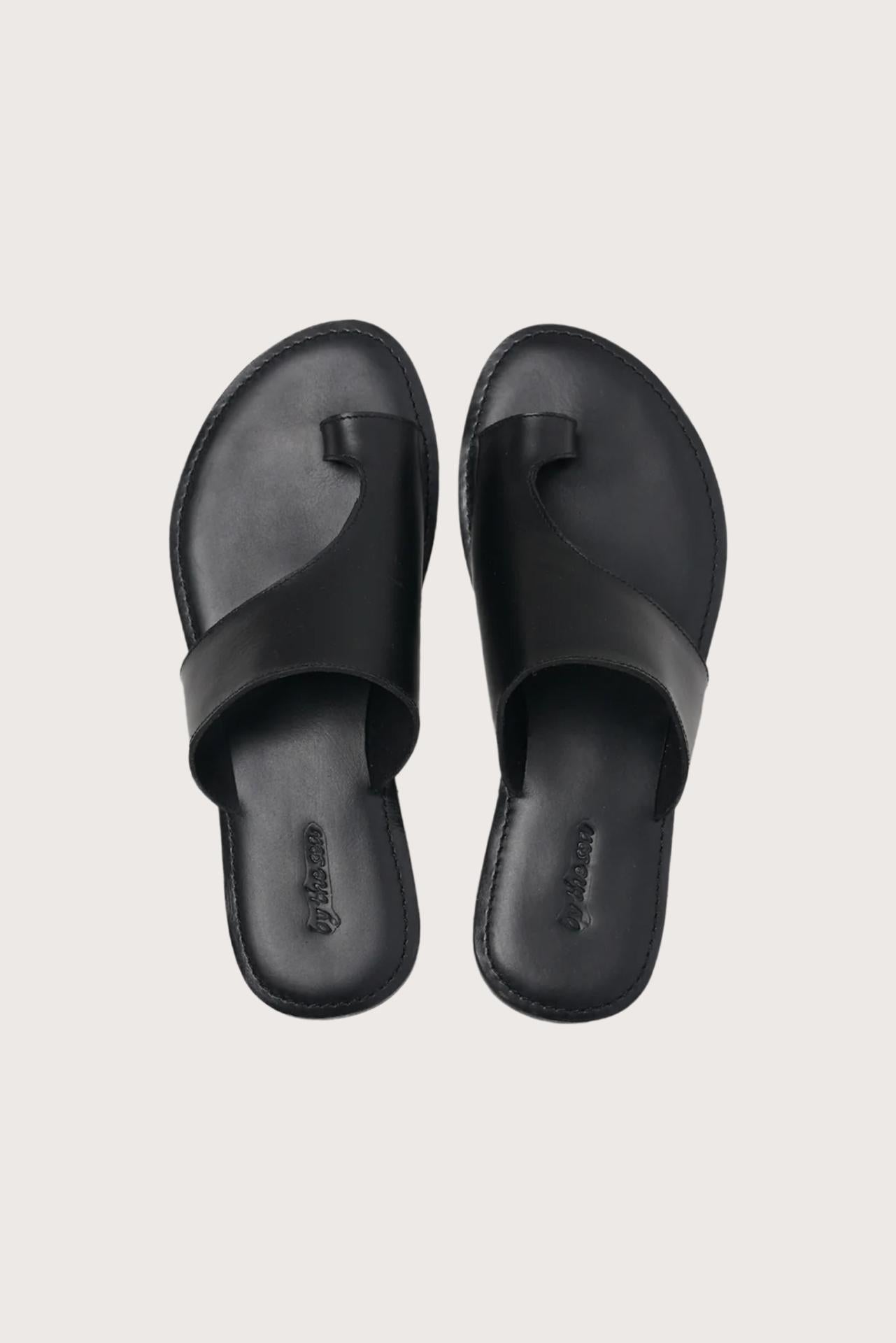 Aida sandal in black shown in a global view highlighting its full silhouette and refined resort design