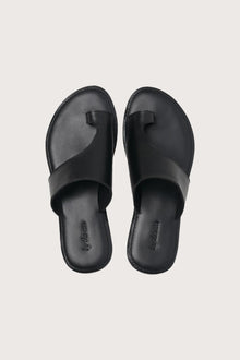 Aida sandal in black shown in a global view highlighting its full silhouette and refined resort design