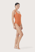 Model wearing Alani One Piece Swimsuit styled for luxury beachwear