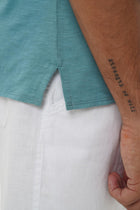 Back detail of the Aling Cotton T-shirt Light Green Forest by By The Sea Bali – premium stitching and artisan quality