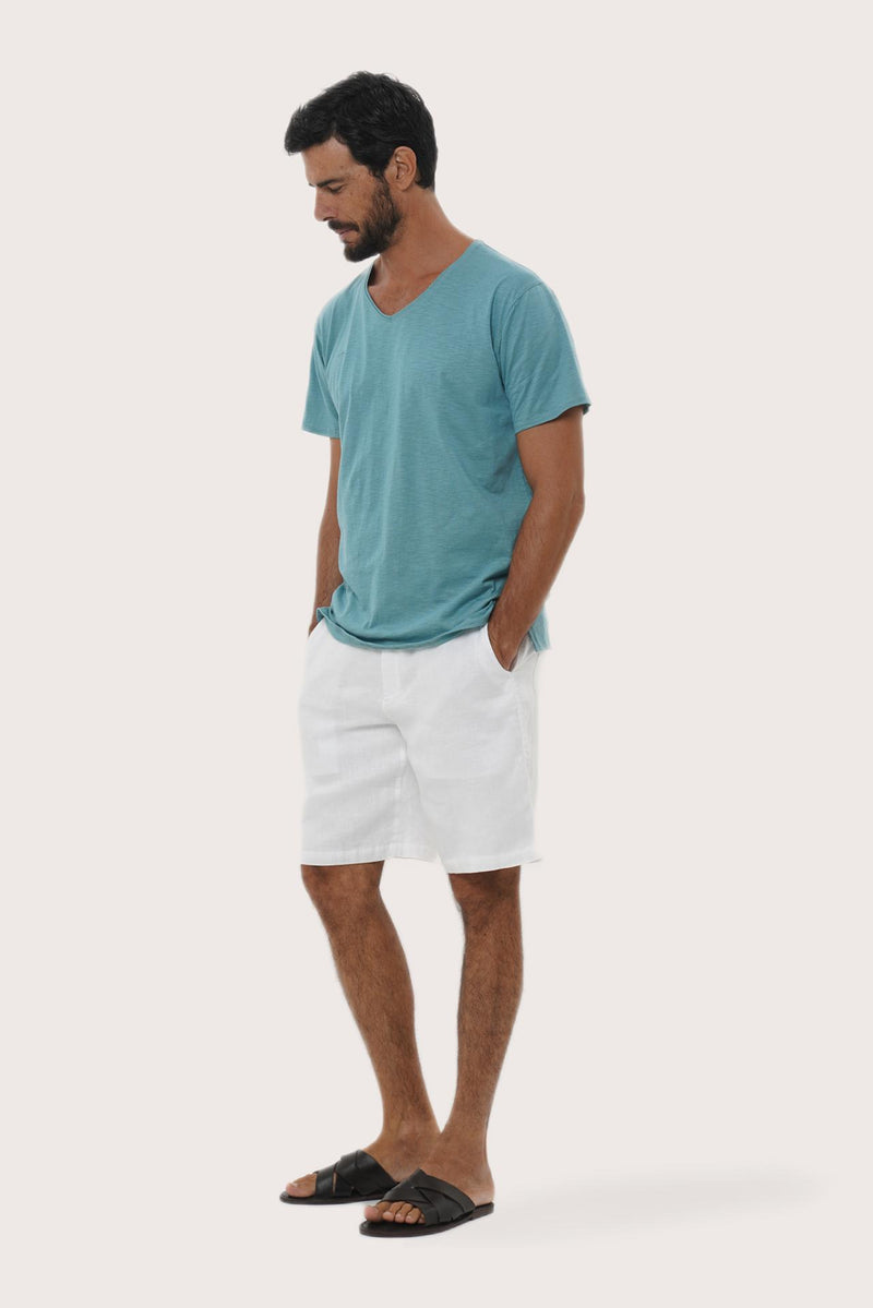 Side profile of the Aling Cotton T-shirt Light Green Forest by By The Sea Bali – relaxed drape and understated island elegance