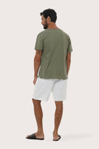 Side profile of the Aling Cotton T-Shirt in Light Sage highlighting the relaxed fit by By The Sea Bali