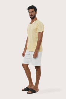 Side profile of the Aling Cotton T-shirt Light Yellow by By The Sea Bali – relaxed drape and understated island elegance