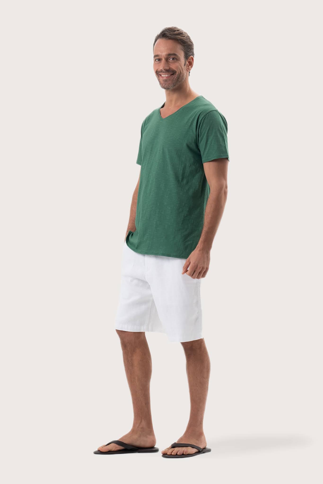 Side profile of the Aling T-Shirt Green by By The Sea Bali – relaxed drape and understated island elegance