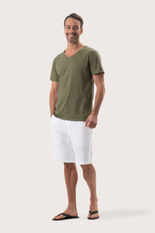Side profile of the Aling T-Shirt Khaki by By The Sea Bali – relaxed drape and understated island elegance