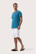 Side profile of the Aling T-Shirt Light Blue by By The Sea Bali – relaxed drape and understated island elegance