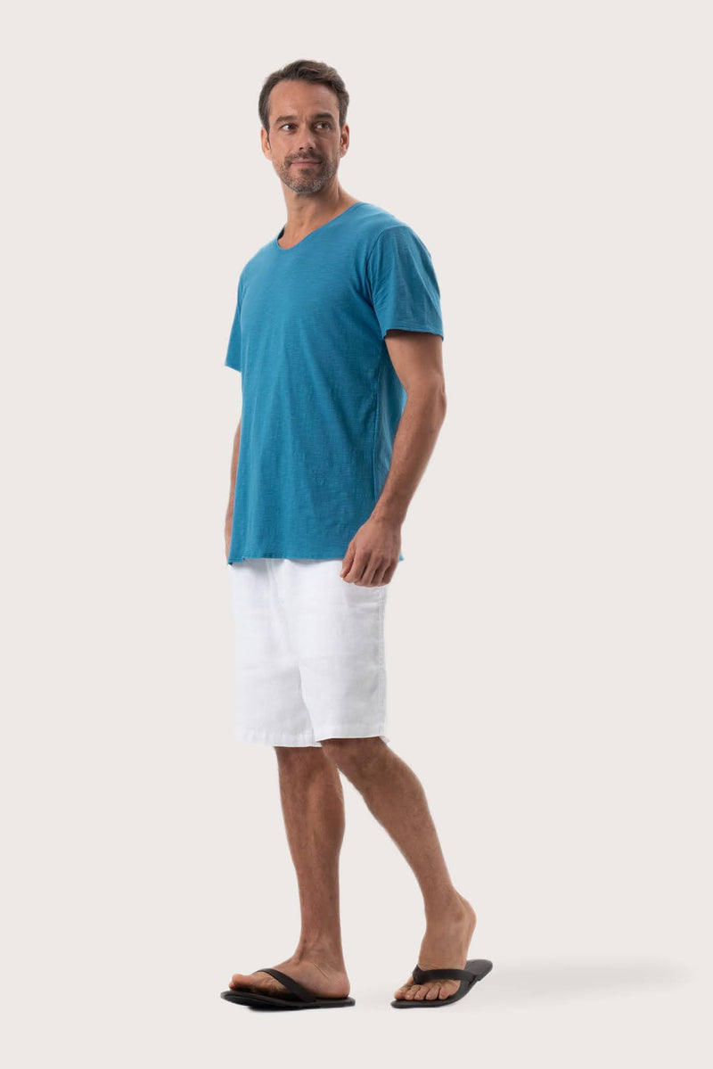 Side profile of the Aling T-Shirt Light Blue by By The Sea Bali – relaxed drape and understated island elegance
