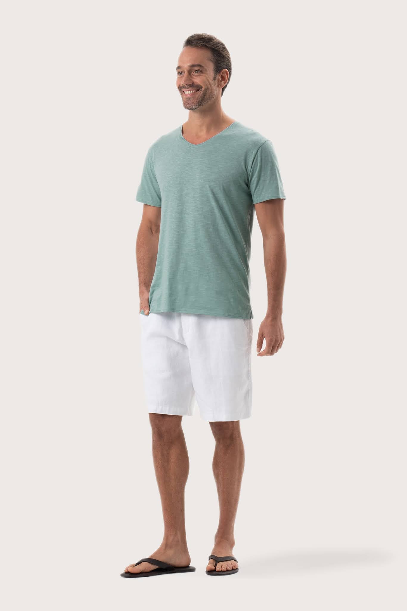 Side profile of the Aling T-Shirt Sage by By The Sea Bali – relaxed drape and understated island elegance