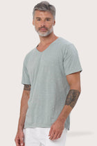 Side profile of the Aling T-Shirt Verde by By The Sea Bali – relaxed drape and understated island elegance