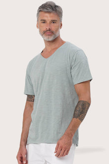 Side profile of the Aling T-Shirt Verde by By The Sea Bali – relaxed drape and understated island elegance
