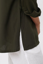 Close up detail of the Amalia Side Slit Shirt Army Green highlighting craftsmanship and design features.
