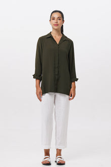 Woman wearing the Amalia Side Slit Shirt Army Green designed for effortless resortwear and tropical living by By The Sea Bali.