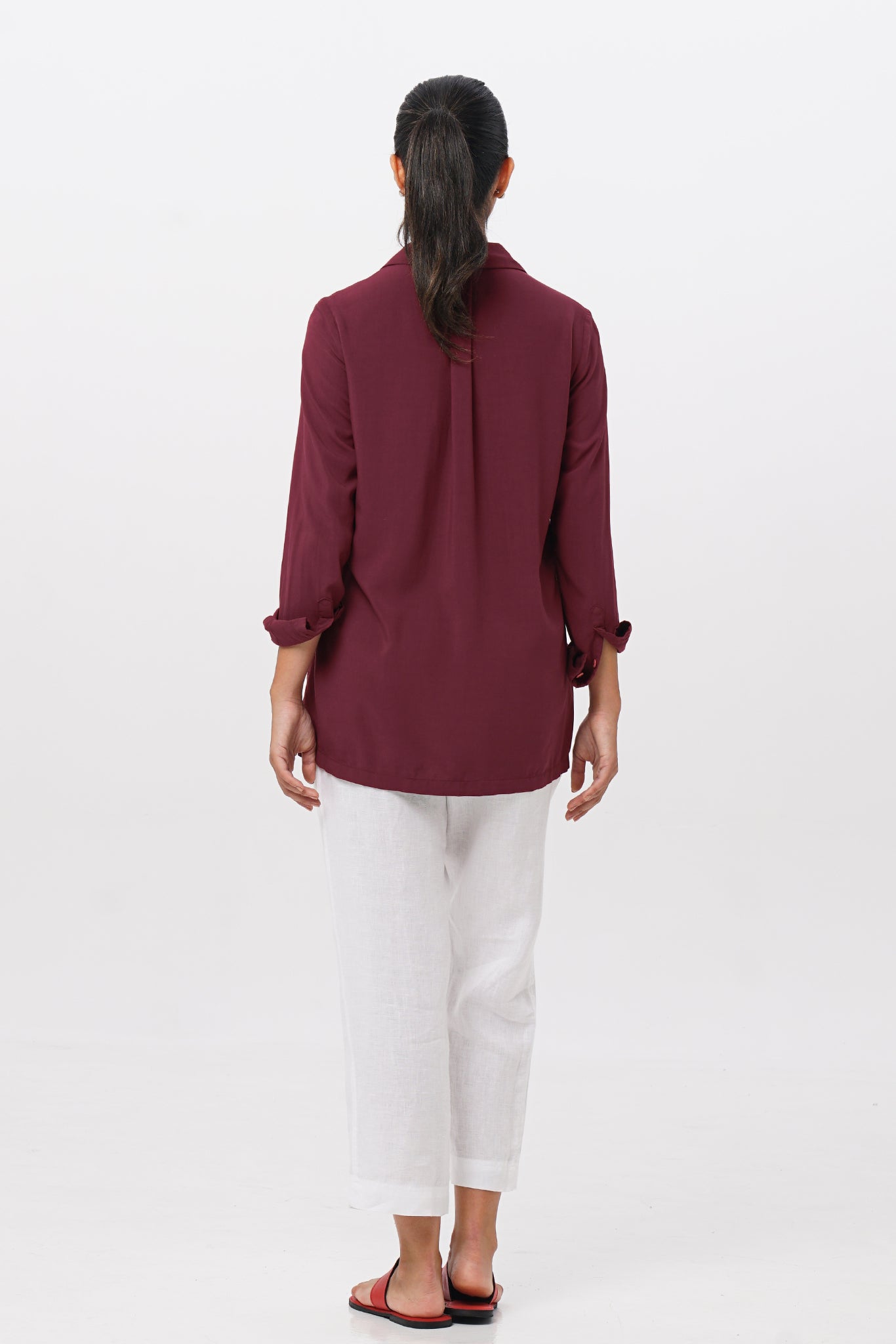 Back view of the Amalia Side Slit Shirt Brick highlighting the garment shape and drape.