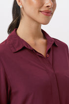 Close up detail of the Amalia Side Slit Shirt Brick highlighting craftsmanship and design features.