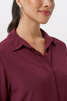 Close up detail of the Amalia Side Slit Shirt Brick highlighting craftsmanship and design features.