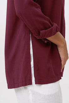 Close up detail of the Amalia Side Slit Shirt Brick highlighting craftsmanship and design features.