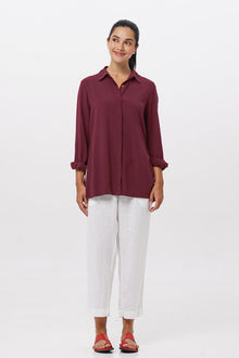 Woman wearing the Amalia Side Slit Shirt Brick designed for effortless resortwear and tropical living by By The Sea Bali.