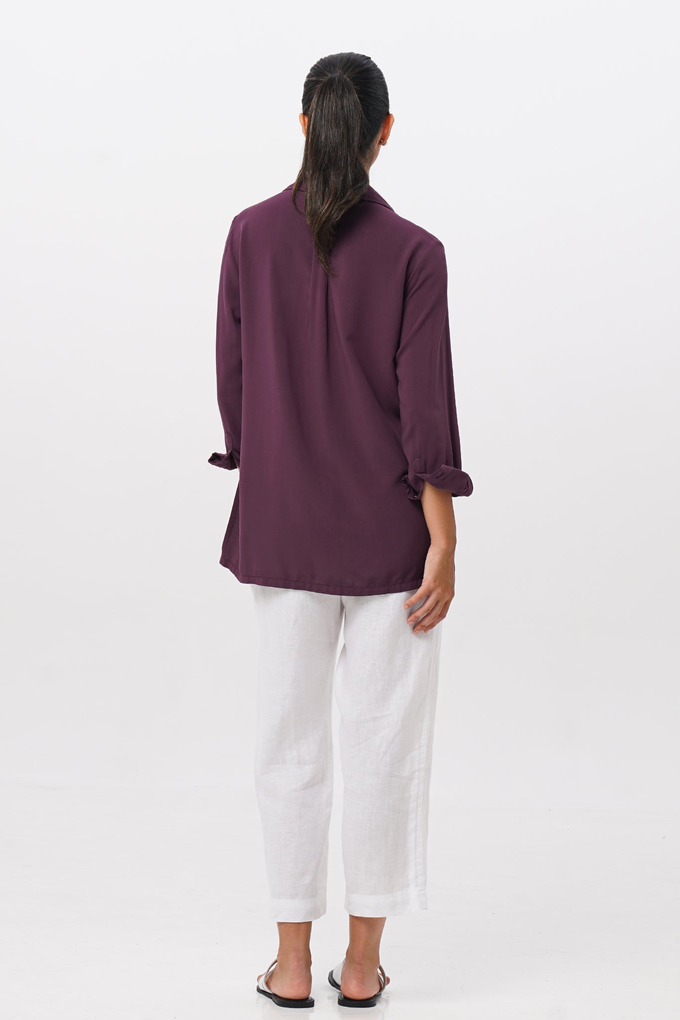 Back view of the Amalia Side Slit Shirt Dark Purple highlighting the garment shape and drape.