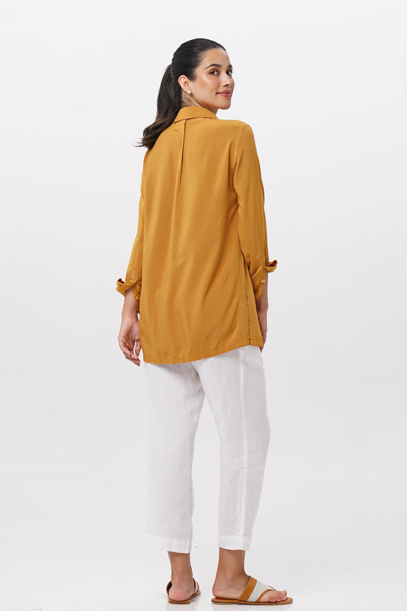 Back view of the Amalia Side Slit Shirt Mustard highlighting the garment shape and drape.