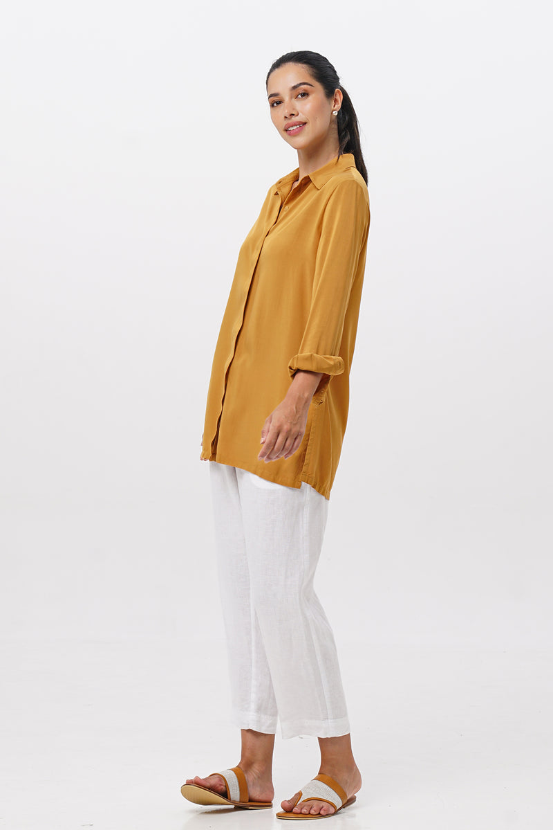 Side profile of the Amalia Side Slit Shirt Mustard showing its cut and natural movement.