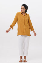 Woman wearing the Amalia Side Slit Shirt Mustard designed for effortless resortwear and tropical living by By The Sea Bali.