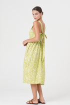 Side profile of the Amara Linen Dress Jungle Leave Light Green showing its cut and natural movement