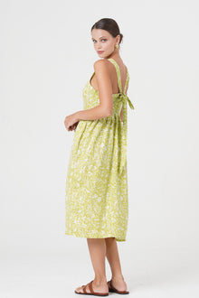 Side profile of the Amara Linen Dress Jungle Leave Light Green showing its cut and natural movement