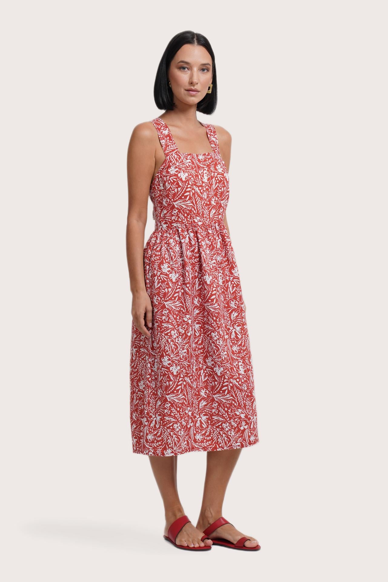 Side profile of the Amara Linen Dress Jungle Leave Red Brick showing its cut and natural movement