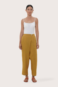 Model wearing the mustard linen Amber pants by By The Sea Bali