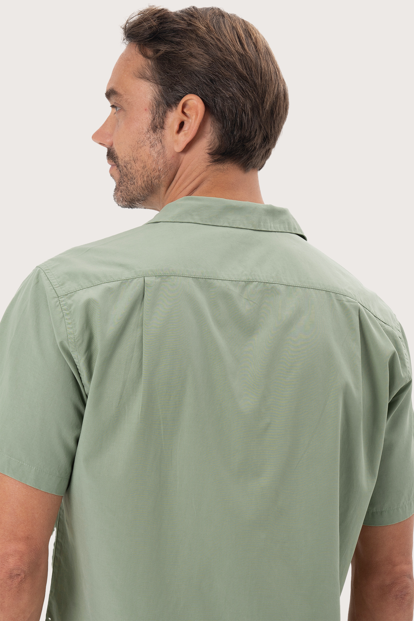 Open collar and button-front detail of the Andres Shirt Sage by By The Sea Bali