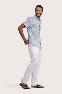 Side profile of the Angkasa Linen Shirt Flower Bloom in Light Blue highlighting its easy, breathable fit by By The Sea Bali