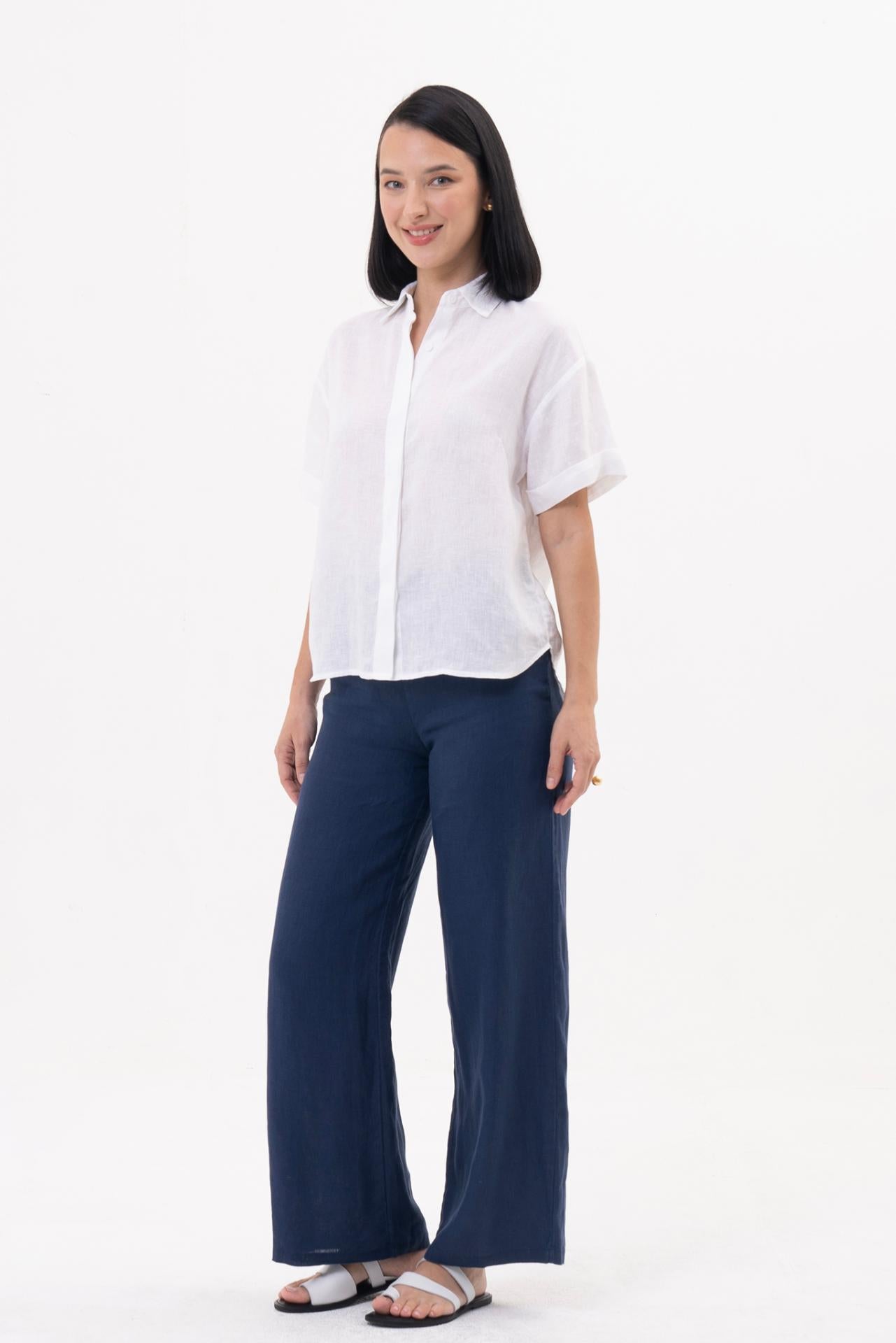 Side profile of the Anse Short Sleeve Linen Blouse White showcasing its relaxed fit and fluid drape