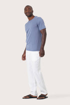 Side profile of the Arco Cotton Knit T-shirt Denim Blue by By The Sea Bali – relaxed drape and understated island elegance