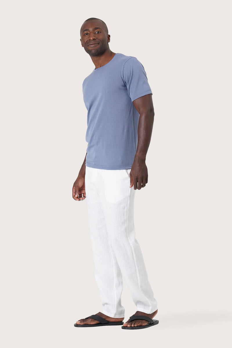 Side profile of the Arco Cotton Knit T-shirt Denim Blue by By The Sea Bali – relaxed drape and understated island elegance