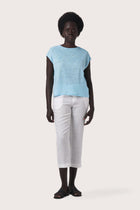 Woman wearing the Aria Linen T-Shirt Cielo designed for effortless resortwear and tropical living by By The Sea Bali.