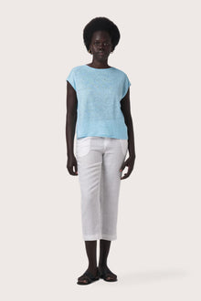 Woman wearing the Aria Linen T-Shirt Cielo designed for effortless resortwear and tropical living by By The Sea Bali.