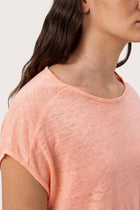 Close up detail of the Aria Linen T-Shirt Peach highlighting craftsmanship and design features.