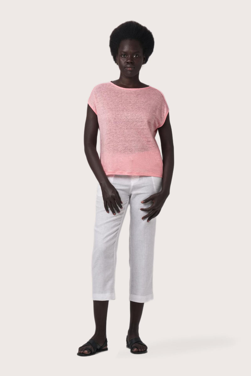 Woman wearing the Aria Linen T-Shirt Rosa designed for effortless resortwear and tropical living by By The Sea Bali.