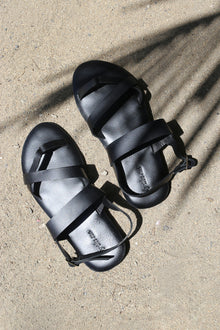 Arus sandal styled on foot in a tropical resort setting with effortless coastal elegance