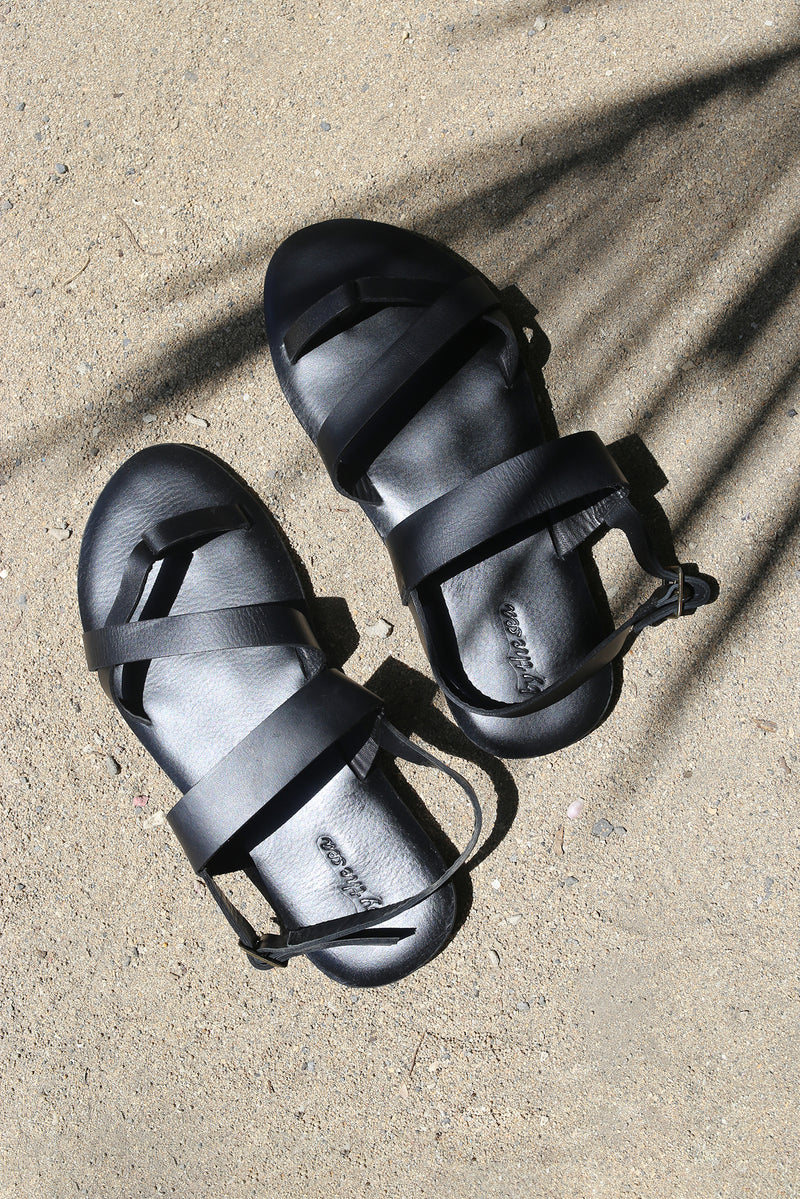 Arus sandal styled on foot in a tropical resort setting with effortless coastal elegance