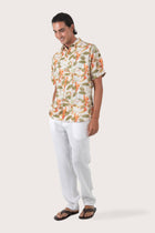 Side profile of the Asa Loose Fit Shirt Begonia in Green highlighting its easy, breathable fit by By The Sea Bali