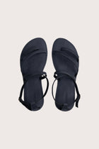 Astola sandal in navy shown in a global view highlighting its full silhouette and refined resort design