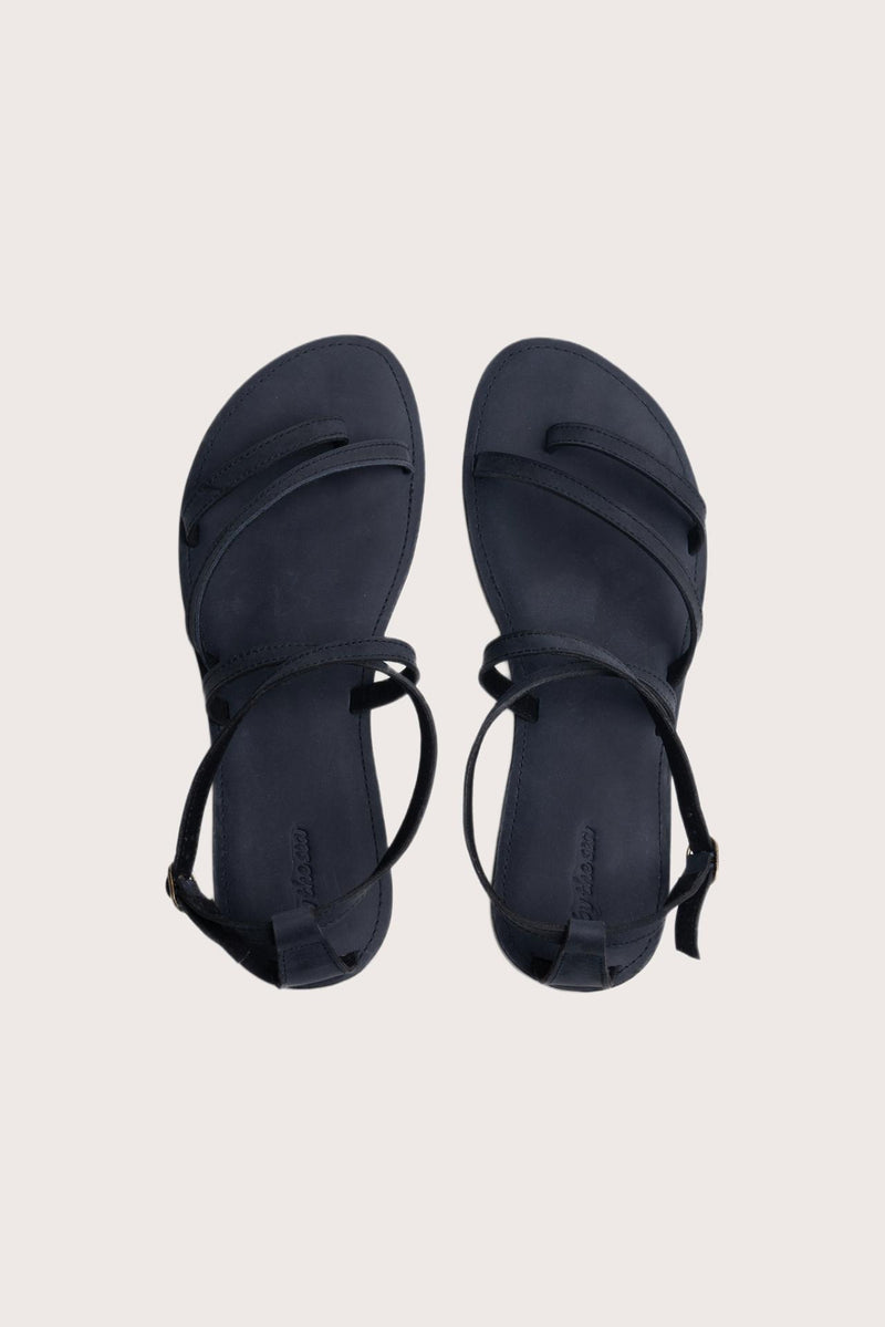 Astola sandal in navy shown in a global view highlighting its full silhouette and refined resort design
